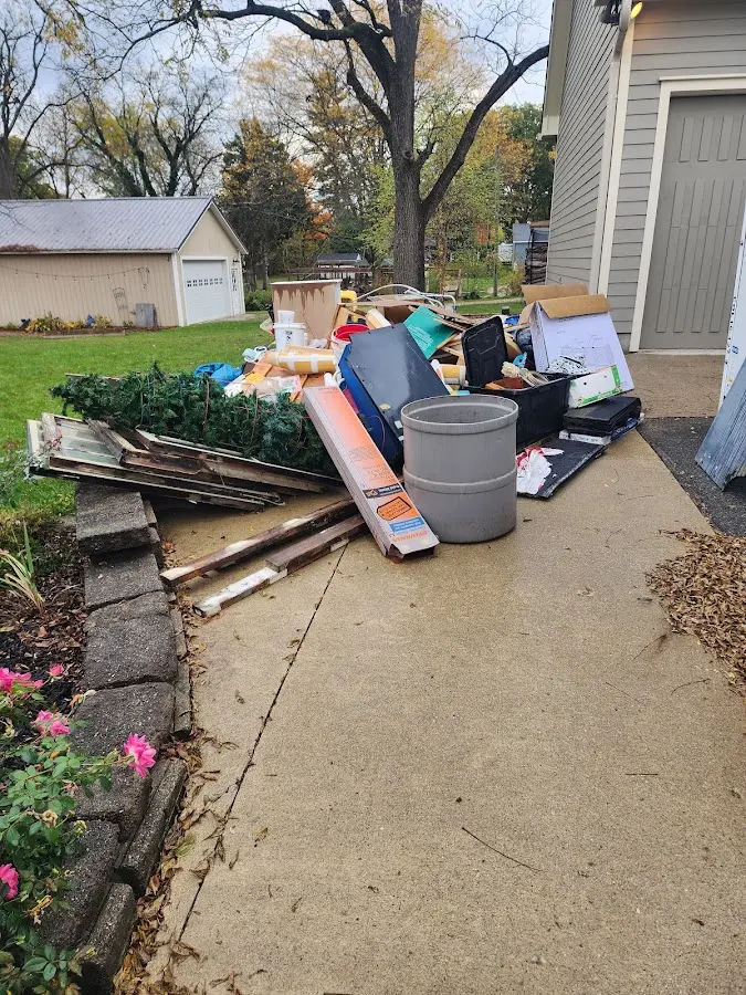 Dumpster being loaded with debris for 12 Yard Dumpster Rental in Newton